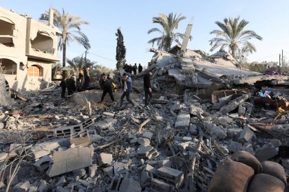 Palestinians inspect the damage at the site of an Israeli strike on a house in Deir al-Balah, central Gaza.