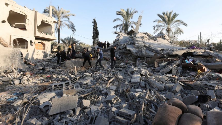 Palestinians inspect the damage at the site of an Israeli strike on a house in Deir al-Balah, central Gaza.