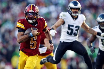 Dec 22, 2024; Landover, Maryland, USA; Washington Commanders quarterback Jayden Daniels (5) runs the ball against the Philadelphia Eagles during the third quarter at Northwest Stadium. Mandatory Credit: Peter Casey-Imagn Images