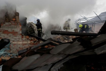 Firefighters work at the site of residential buildings hit by a Russian strike in Kharkiv, Ukraine, on December 25.