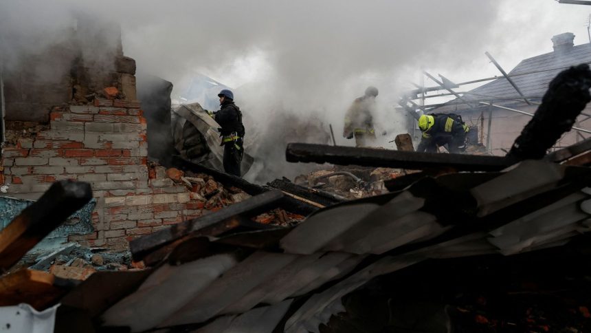 Firefighters work at the site of residential buildings hit by a Russian strike in Kharkiv, Ukraine, on December 25.