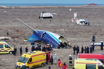 Emergency workers operate at the crash site of the Azerbaijan Airlines passenger plane near the city of Aktau, Kazakhstan on December 25.