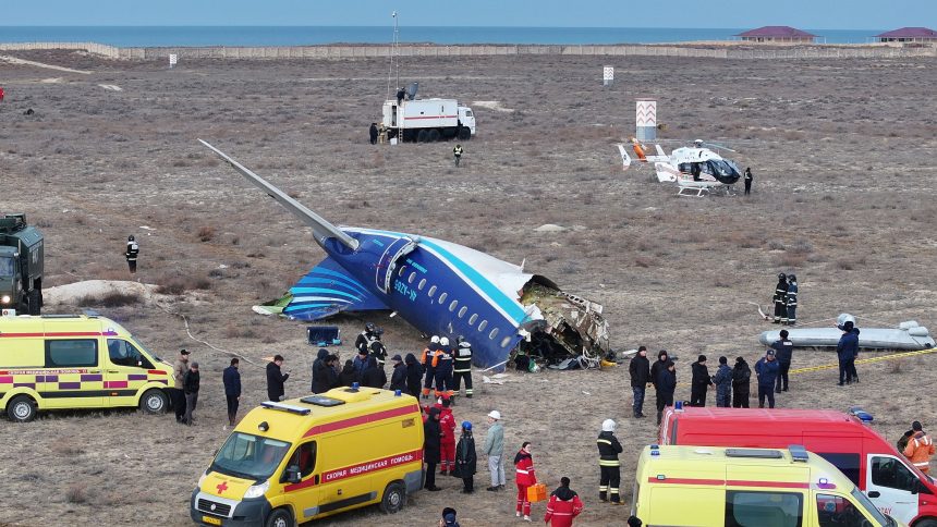 Emergency workers operate at the crash site of the Azerbaijan Airlines passenger plane near the city of Aktau, Kazakhstan on December 25.