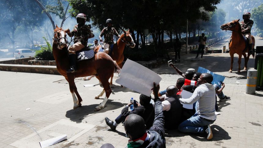 Riot police lob tear gas canisters as they attempt to disperse protesters, demonstrating against what they say is a wave of unexplained abductions of government critics, in downtown Nairobi, Kenya, on Monday.