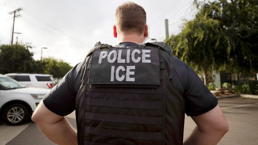 FILE - A U.S. Immigration and Customs Enforcement (ICE) officer looks on during an operation in Escondido, Calif.,  July 8, 2019.  Immigration enforcement arrests in the interior of the U.S. fell over the past year as the Biden administration shifted its enforcement focus to people in the country without legal status who have committed serious crimes.