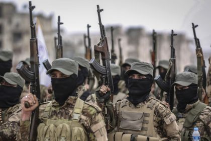 Fighters from the Popular Resistance Brigades, a local militia, take part in a military parade in Idlib city during their graduation from a military course in the presence of the prime minister of the Syrian Salvation Government on February 17, 2022.