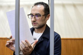 Eugene Spector behind bars in a Moscow courtroom in February 2020.