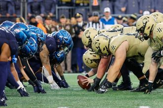 The Black Knights and the Midshipmen prepare for battle at the line of scrimmage during the 2023 edition of the Army-Navy game.