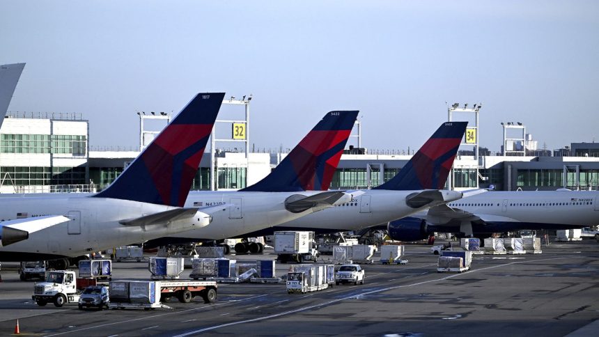 Delta Airlines planes stand at their terminal in New York's John F. Kennedy International Airport.