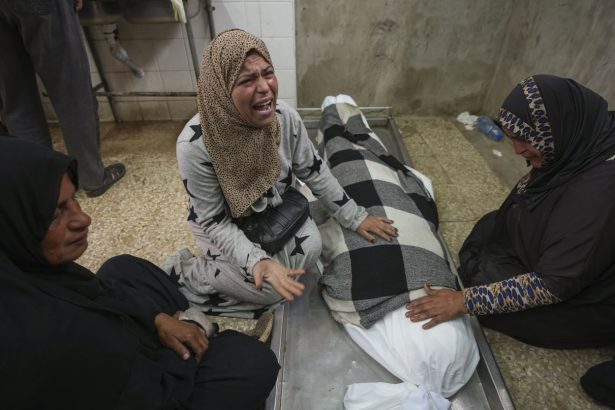 Relatives mourn over the body of 17-year-old Rahaf Abu Laban in Deir al-Balah after she was crushed to death as a crowd of Palestinians pushed to get bread at a bakery.