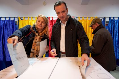 People post their votes in Romania's parliamentary elections in Bucharest, Romania, on Sunday, December 1.