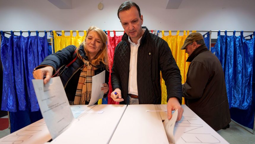 People post their votes in Romania's parliamentary elections in Bucharest, Romania, on Sunday, December 1.