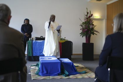 Father Stephen of Ugar Island, Australia, blesses coffins during a ceremony for the return of Aboriginal Australians' ancestors to their relatives and communities at the Ethnological Museum in Berlin on Thursday, December 5, 2024.