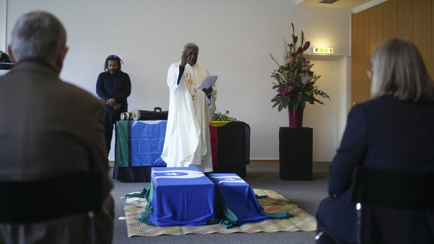 Father Stephen of Ugar Island, Australia, blesses coffins during a ceremony for the return of Aboriginal Australians' ancestors to their relatives and communities at the Ethnological Museum in Berlin on Thursday, December 5, 2024.