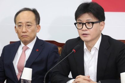 South Korea's ruling People Power Party leader Han Dong-hun, right, speaks during a press conference at the National Assembly in Seoul, South Korea, Friday, Dec. 6, 2024. (Jo Sung-bong/Newsis via AP)