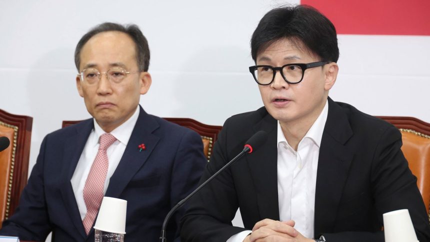 South Korea's ruling People Power Party leader Han Dong-hun, right, speaks during a press conference at the National Assembly in Seoul, South Korea, Friday, Dec. 6, 2024. (Jo Sung-bong/Newsis via AP)