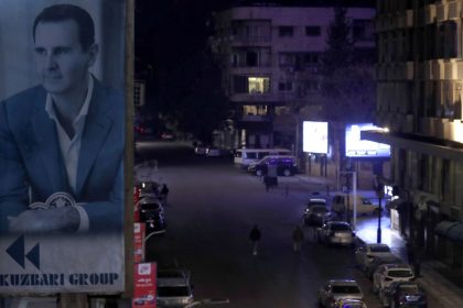 A portrait of Syrian President Bashar al-Assad is seen on a building in Damascus, Syria, on December 7.