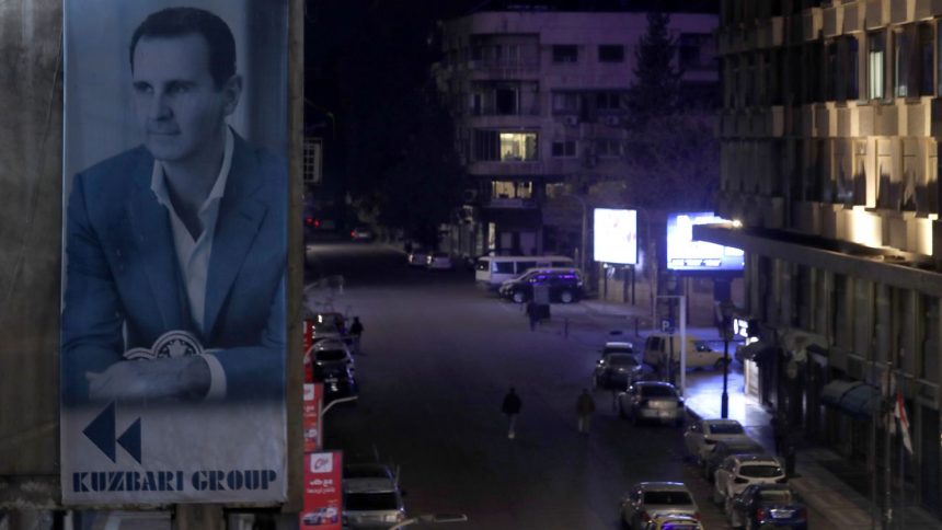 A portrait of Syrian President Bashar al-Assad is seen on a building in Damascus, Syria, on December 7.