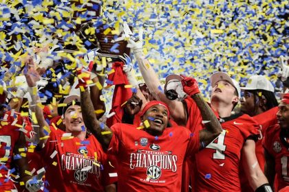 Georgia players celebrate after winning the SEC Championship over Texas.