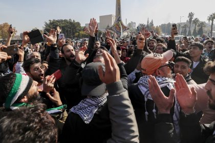 Syrians celebrate at Omayyad Square in Aleppo, Syria, Monday, Dec. 9, 2024. (AP Photo/Omar Sanadiki)