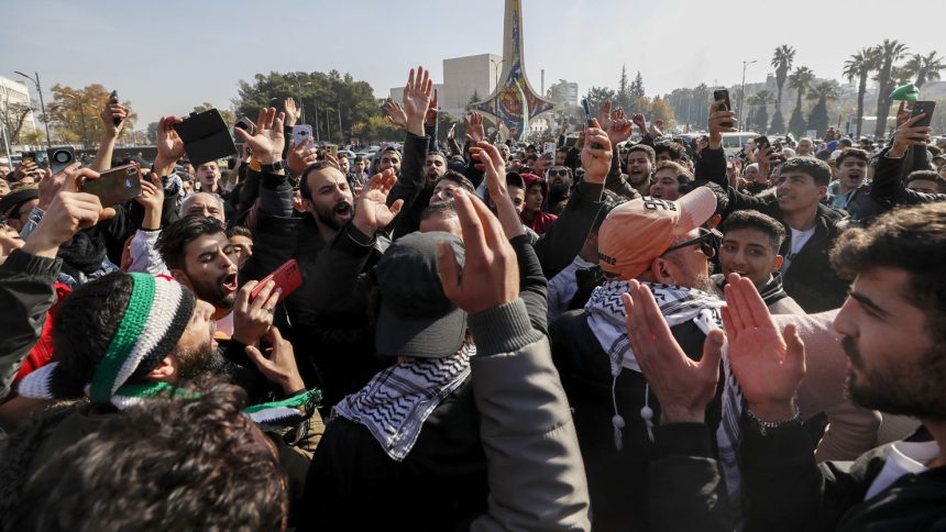 Syrians celebrate at Omayyad Square in Aleppo, Syria, Monday, Dec. 9, 2024. (AP Photo/Omar Sanadiki)