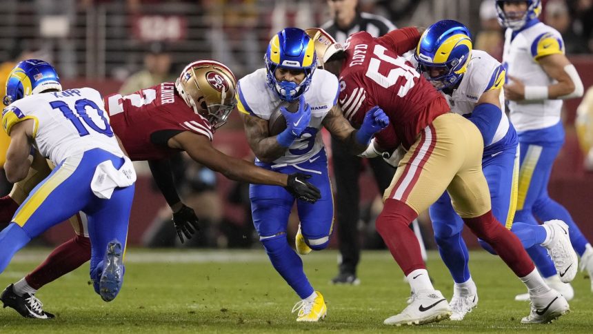 Los Angeles Rams running back Kyren Williams, middle, runs against the San Francisco 49ers.