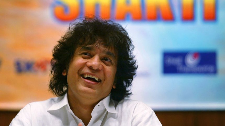 Zakir Hussain laughs during a press conference to announce a musical concert in Mumbai, India, on December 8, 2006.