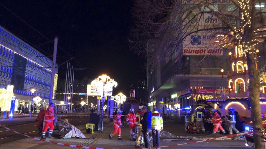 Emergency services and firefighters attend the scene at the Christmas market in Magdeburg on December 20.