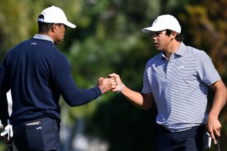 Tiger Woods and Charlie Woods share a fist bump at the PNC Championshipon Saturday.