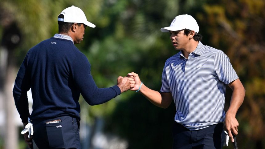 Tiger Woods and Charlie Woods share a fist bump at the PNC Championshipon Saturday.