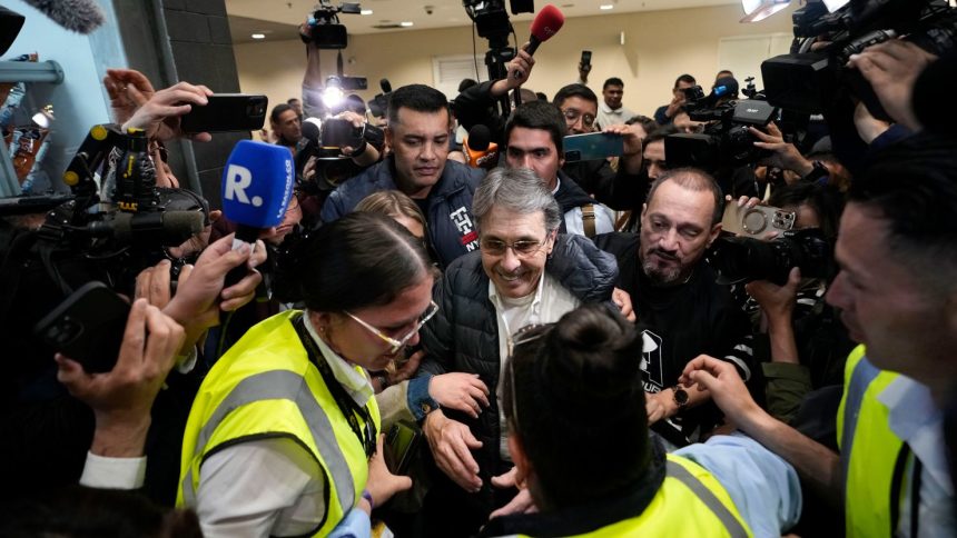 Media swarm Fabio Ochoa, center, a former member of the Medellin cartel, upon his arrival at El Dorado airport in Bogota, Colombia, December 23, 2024.