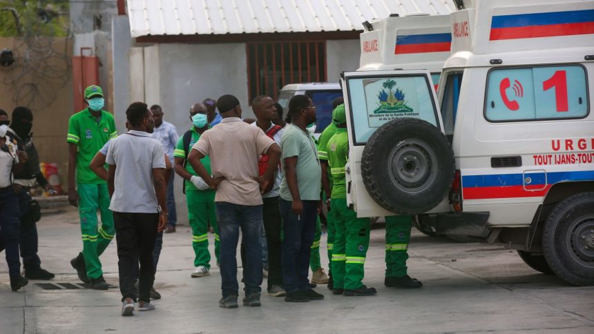 Medics inspect an ambulance of wounded people, shot by armed gangs at the General Hospital, in Port-au-Prince, Haiti, on Tuesday, December 24.