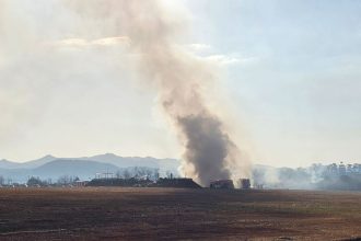 Firefighters work to extinguish a fire off the runway of Muan International Airport in Muan, South Korea, Sunday, Dec. 29, 2024. (Maeng Dae-hwan/Newsis via AP)