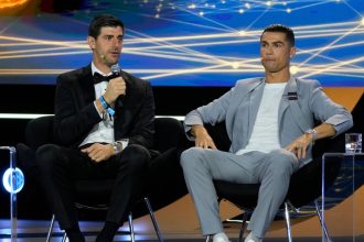 Cristiano Ronaldo and Thibaut Courtois take the podium at the 15th Edition of the Globe Soccer Awards in Dubai on December 27.