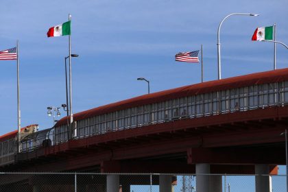 A bridge with Mexican and US flags is seen on the border of El Paso, in the United States, and Ciudad Juarez in Mexico, on November 28.