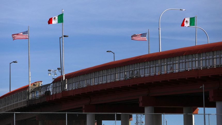 A bridge with Mexican and US flags is seen on the border of El Paso, in the United States, and Ciudad Juarez in Mexico, on November 28.