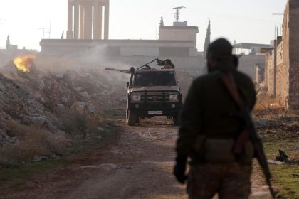 Fighters fire towards Syrian Army troops in the Al-Rashidin District on the outskirts of Aleppo on November 29.