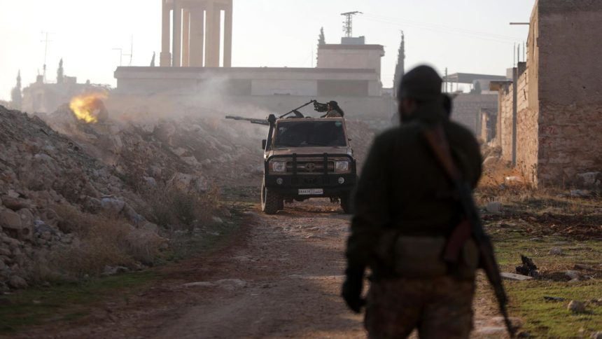 Fighters fire towards Syrian Army troops in the Al-Rashidin District on the outskirts of Aleppo on November 29.