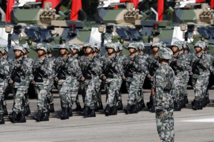 In this 2017 photo, People's Liberation Army troops march during a visit by Chinese President Xi Jinping, not pictured, at the Shek Kong Barracks in Hong Kong.