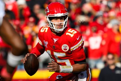 Kansas City Chiefs quarterback Patrick Mahomes looks to pass while scrambling away from Houston Texans pressure Saturday, December 21 in Kansas City, Missouri.