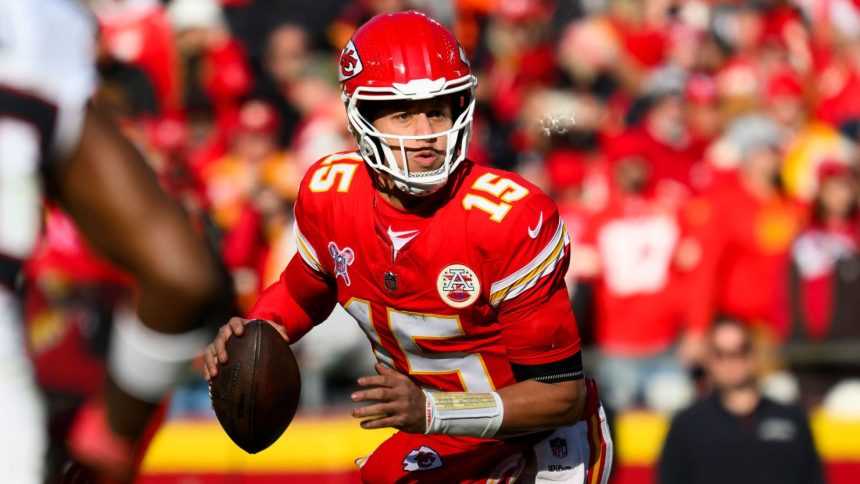 Kansas City Chiefs quarterback Patrick Mahomes looks to pass while scrambling away from Houston Texans pressure Saturday, December 21 in Kansas City, Missouri.