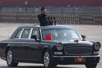 BEIJING, CHINA - OCTOBER 01: Chinese President Xi Jinping waves as he drives after inspecting the troops during a parade to celebrate the 70th Anniversary of the founding of the People's Republic of China at Tiananmen Square in 1949, on October 1, 2019 in Beijing, China. (Photo by Kevin Frayer/Getty Images)