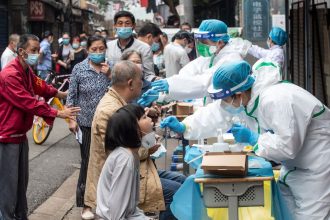 Medical workers test residents for Covid-19 in the city of Wuhan in China's central Hubei province on May 15, 2020.