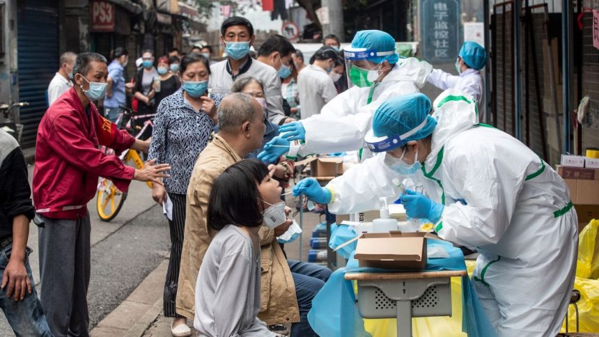 Medical workers test residents for Covid-19 in the city of Wuhan in China's central Hubei province on May 15, 2020.