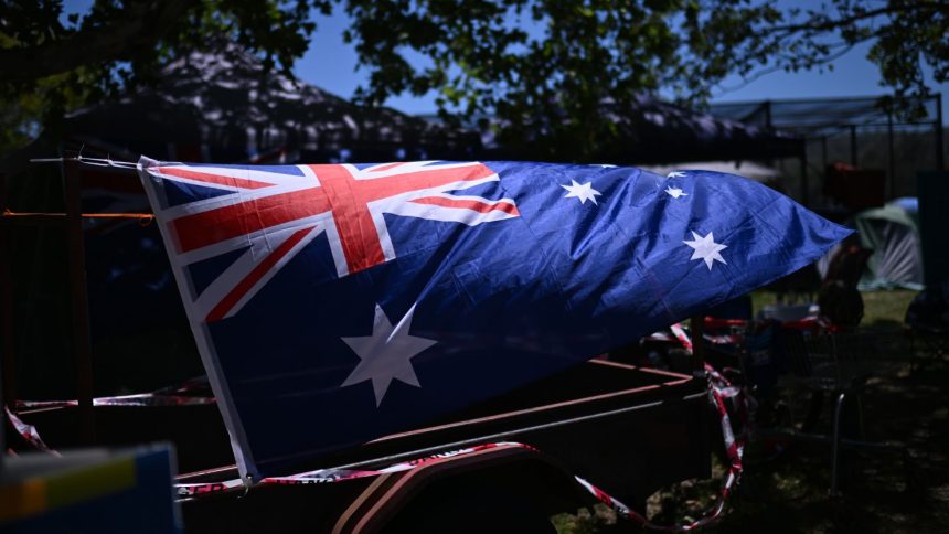 TAMWORTH, AUSTRALIA - JANUARY 26: The Australian flag is attached to a trailer at a campground during Australia Day on January 26, 2024 in Tamworth, Australia. Australia Day, formerly known as Foundation Day, is the official national day of Australia and is celebrated annually on January 26 to commemorate the arrival of the First Fleet to Sydney in 1788. Many indigenous Australians refer to the day as Invasion Day and there is a growing movement to change the date to one which can be celebrated by all Australians. In 2024, supermarket chains Woolworths and Aldi announced that they will stop stocking themed merchandise for the day, drawing a political backlash from opposition leader Peter Dutton. (Photo by Dan Peled/Getty Images)