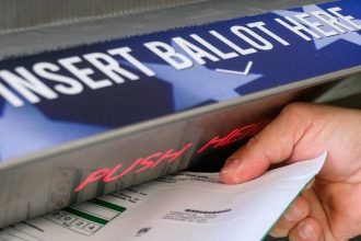 A voter casts a ballot for the US election in Doylestown, Pennsylvania, October 31, 2024.