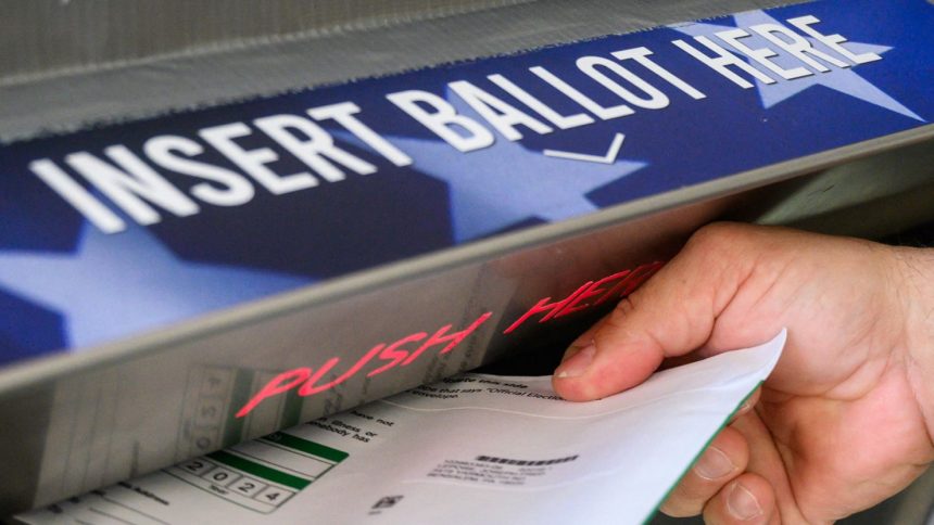 A voter casts a ballot for the US election in Doylestown, Pennsylvania, October 31, 2024.