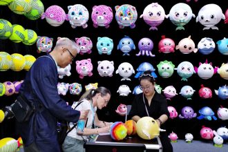 People visit a booth of toys during the third phase of the 136th China Import and Export Fair at the Canton Fair Complex on October 31, 2024 in Guangzhou, Guangdong Province of China.