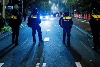 Police officers stand near a pro-Palestinian demonstration during a soccer match between Ajax Amsterdam and Maccabi Tel Aviv in Amsterdam, The Netherlands, in November.