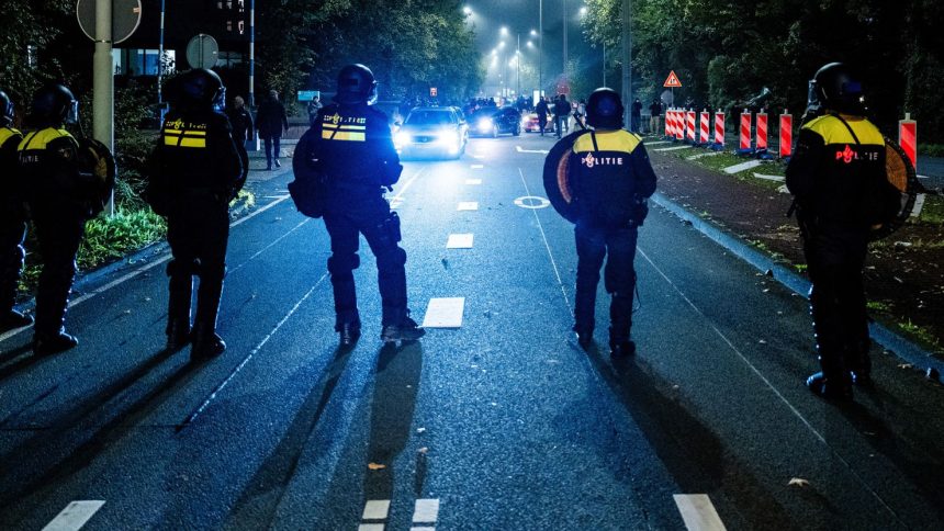 Police officers stand near a pro-Palestinian demonstration during a soccer match between Ajax Amsterdam and Maccabi Tel Aviv in Amsterdam, The Netherlands, in November.